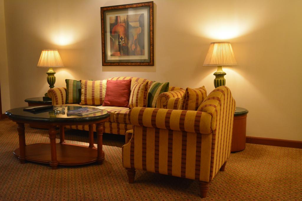 The Orchid Hotel Mumbai Vile Parle Extérieur photo A living room with a sofa